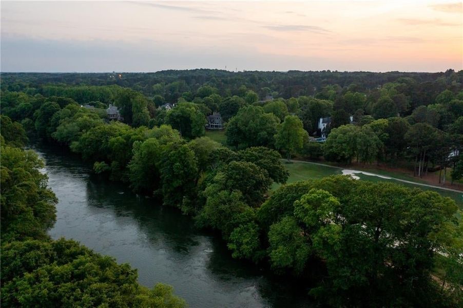 Aerial view at dusk featuring a water view