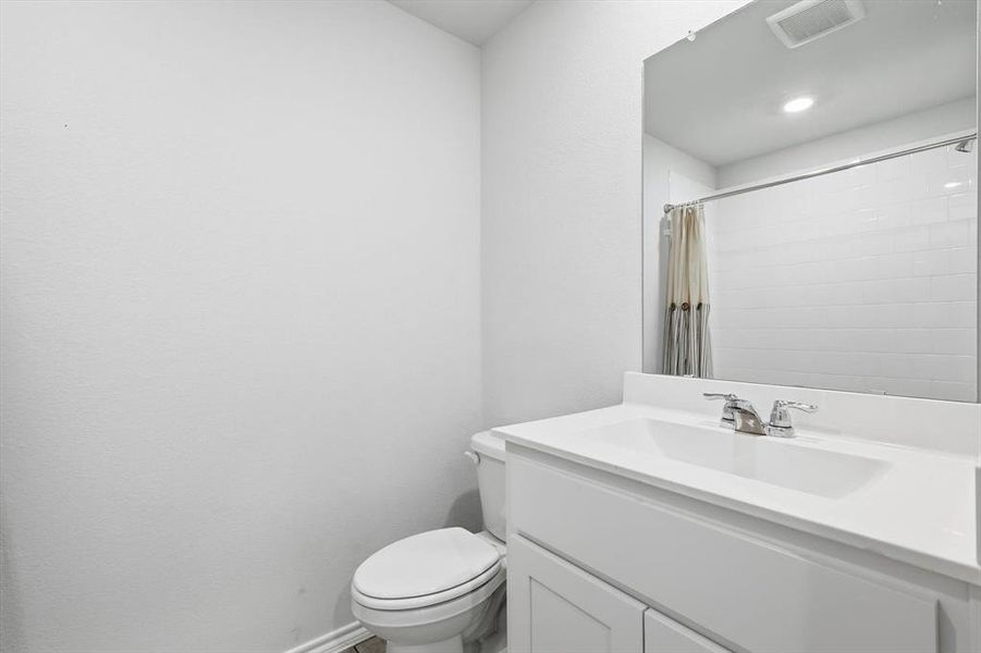 Full guest bath with tub/shower, toilet and vanity Full guest bath with tub/shower, toilet and vanity