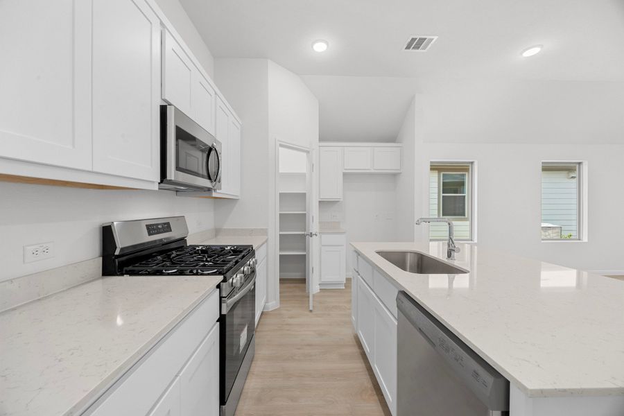 Kitchen in the Cypress home plan by Trophy Signature Homes - REPRESENTATIVE PHOTO