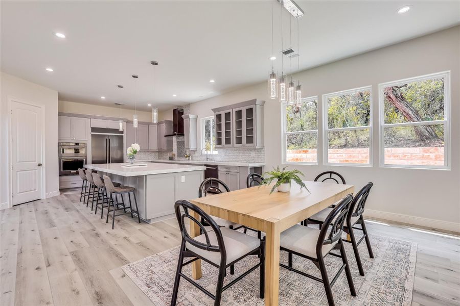 Dining area with light hardwood / wood-style floors