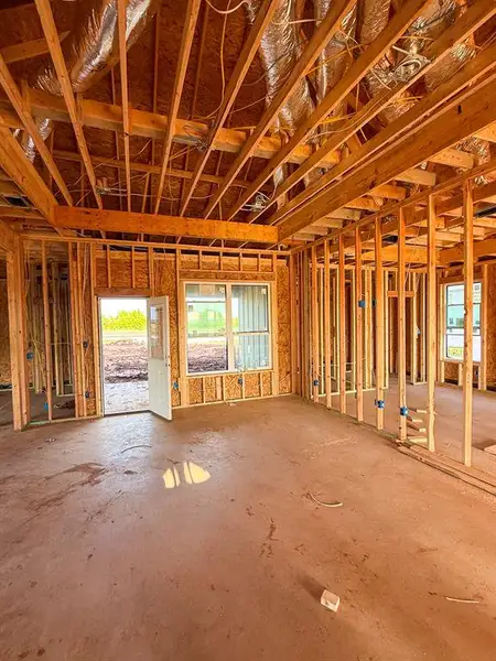 The property is currently under construction, featuring exposed wooden framing and a concrete subfloor