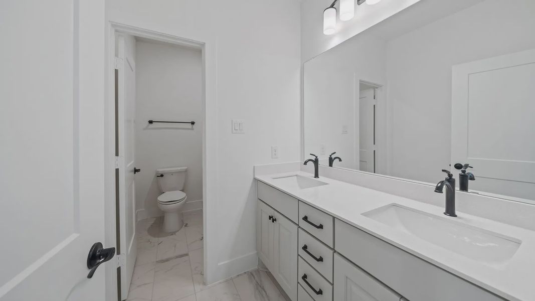 Representative furnished interior of a home built from the Waterloo by Chesmar Homes in Attwater 65's, Waller (Image 14).