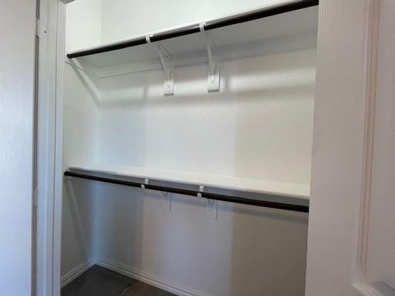 Closets featuring double rods with shelves and wood-style floors Closets featuring double rods with shelves and wood-style floors