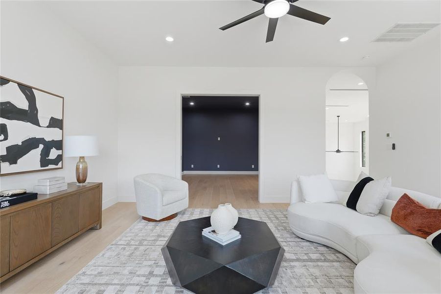 Spacious room featuring light wood-finish flooring and recessed lighting Spacious room featuring light wood-finish flooring and recessed lighting