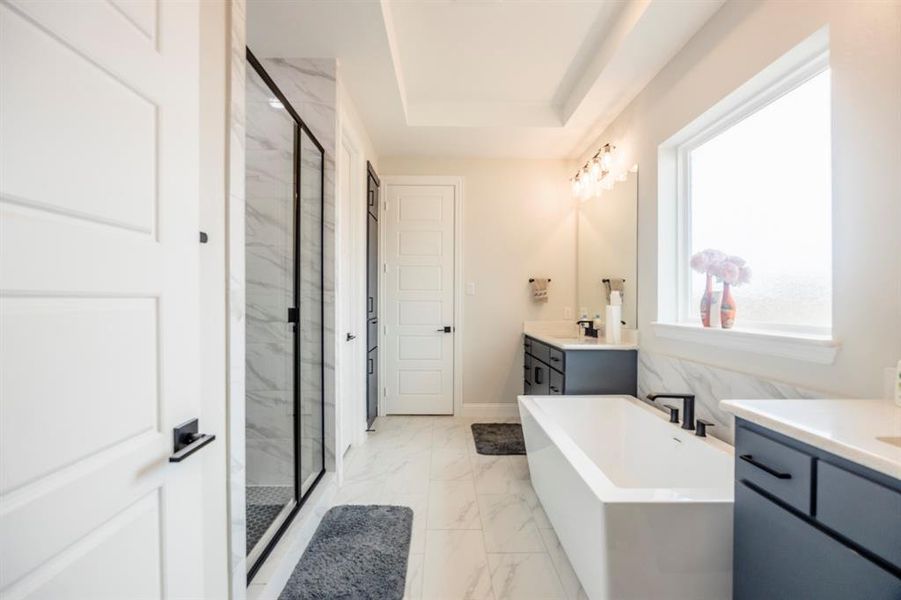 Full bath with a marble finish shower, a soaking tub, marble finish floor, and vanity