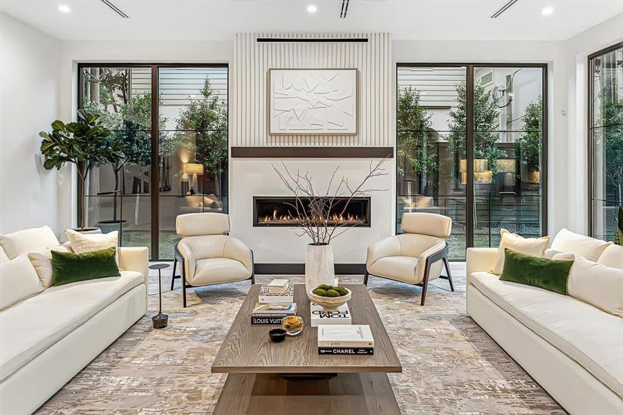 [Family Room] - Previous home built by SJS. Sunlight streams into the family room through expansive large windows - warm and inviting. Linear gas fireplace with white stone surround.