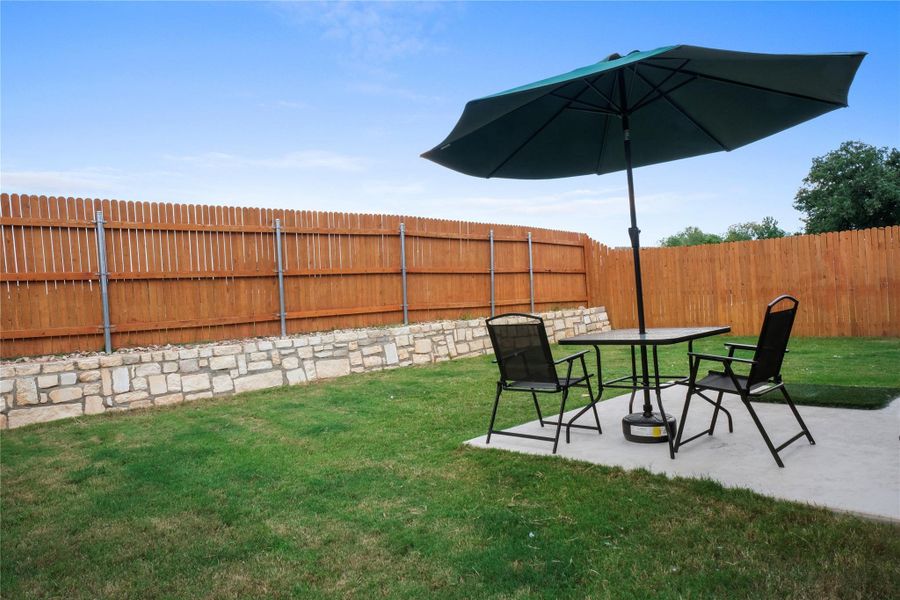 Fenced backyard with a patio area