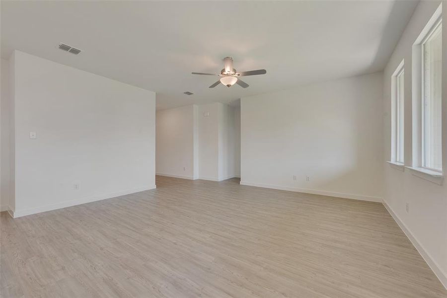 Spare room with light hardwood / wood-style floors and ceiling fan