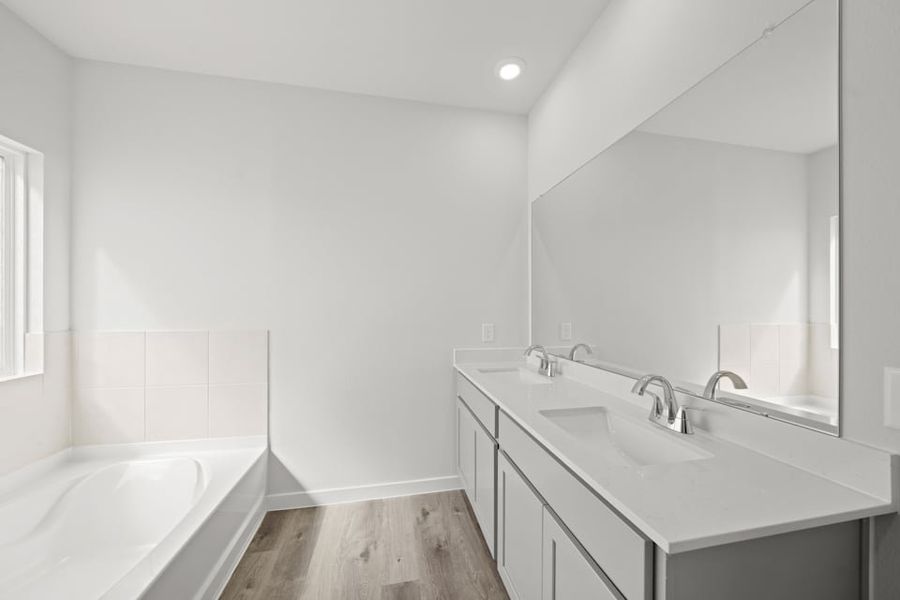 A bathroom with a large mirror.