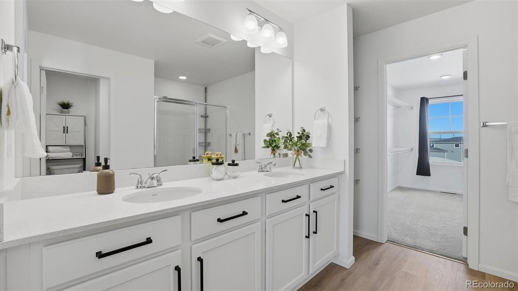 Primary Bathroom with double sink vanity and mirror.
