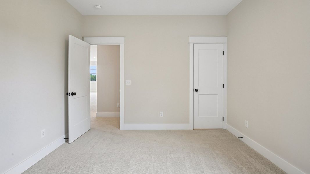Bedroom with carpet and closet Bedroom with carpet and closet