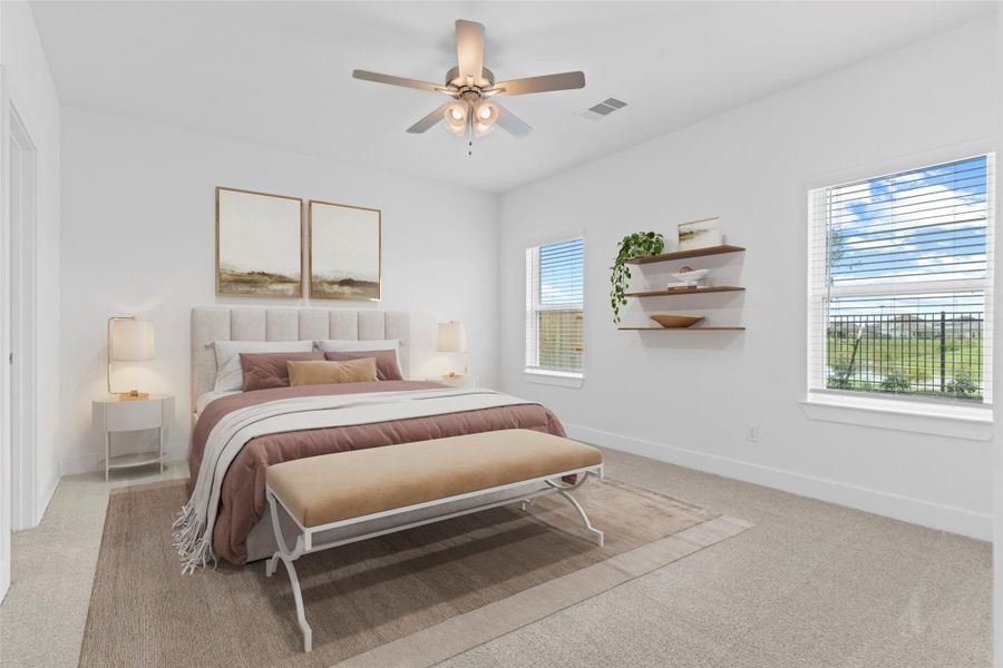 Spacious primary bedroom offers plush carpet, large windows with backyard and lake views, a ceiling fan, and plenty of wall space for oversized furniture. *Virtually Staged* **Image Representative of Plan Only and May Vary as Built**.
