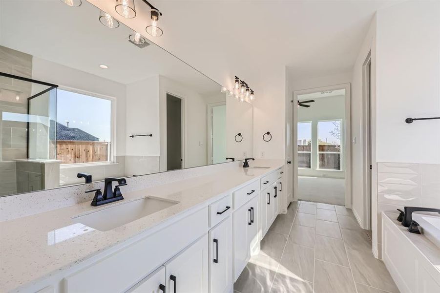 Bathroom featuring vanity, plenty of natural light, and plus walk in shower