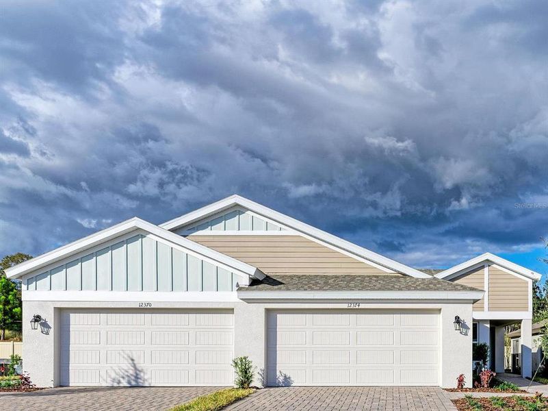 Front exterior of a new home in Crosswind Point, Parrish, FL, highlighting curb appeal (Image 1). Front exterior of a new home in Crosswind Point, Parrish, FL, highlighting curb appeal (Image 1).