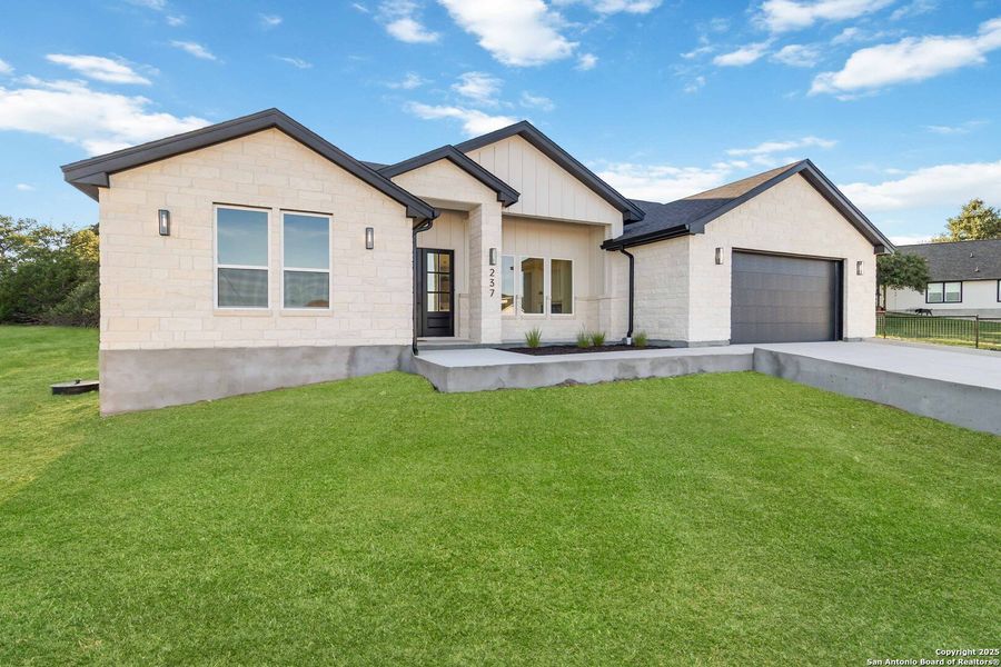 Front exterior of a new home in , Blanco, TX, highlighting curb appeal (Image 23).