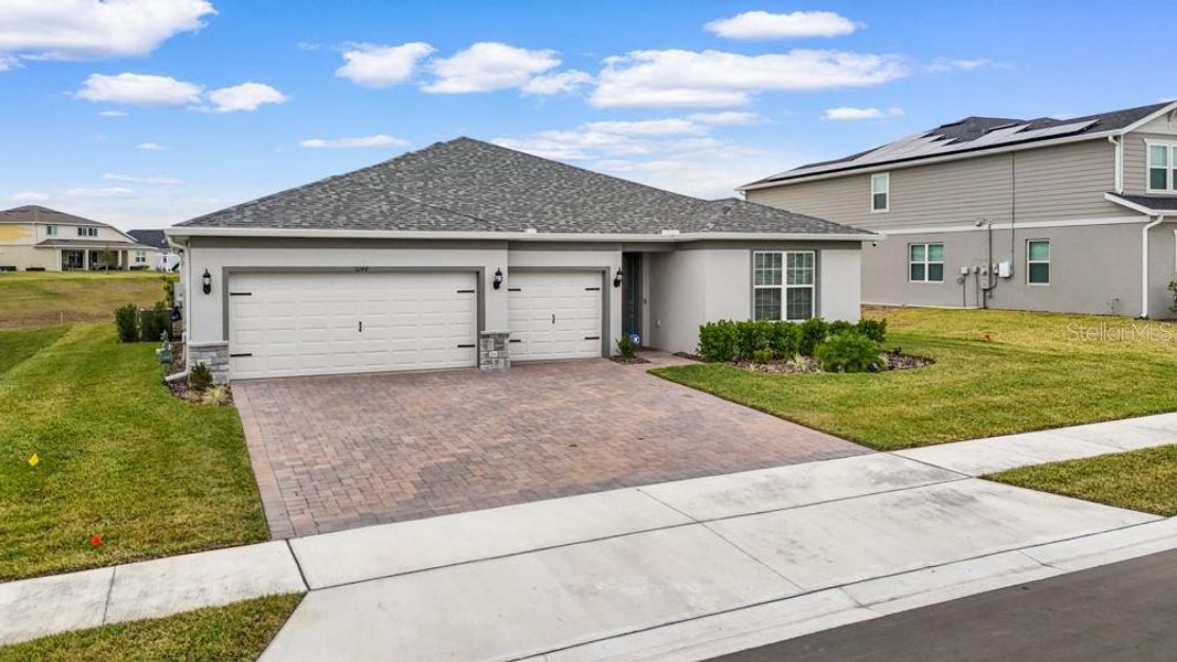 Front exterior of a new home in Foothills Preserve, Mount Dora, FL, highlighting curb appeal (Image 25).