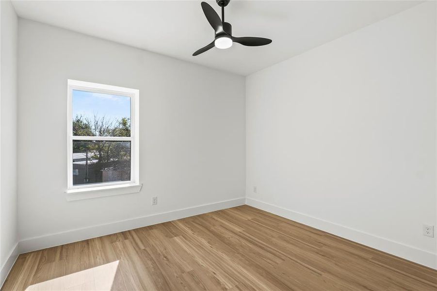Spare room featuring wood finished floors and a ceiling fan