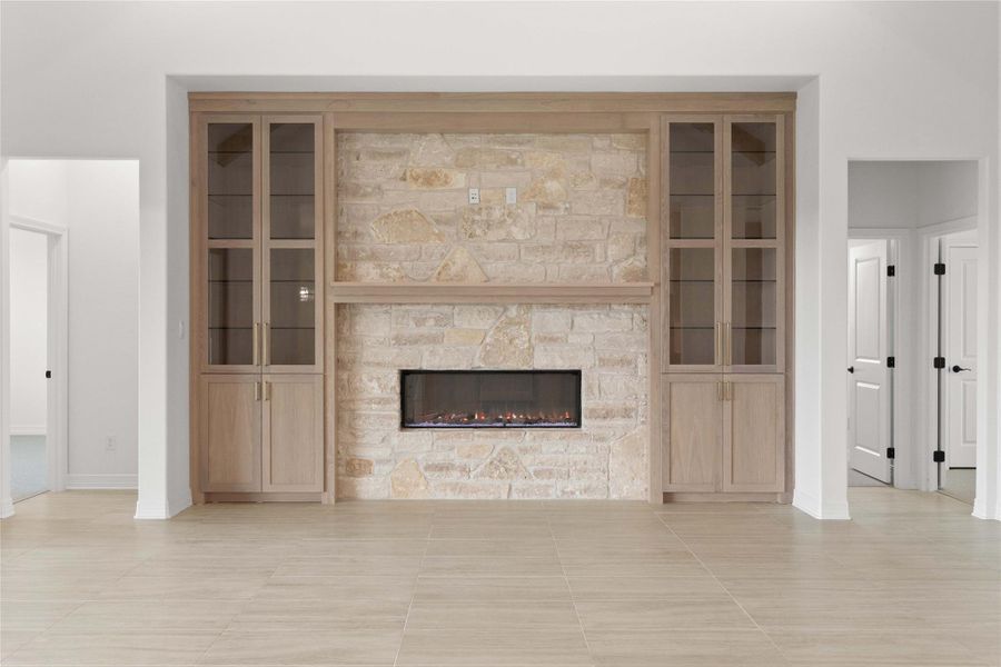 A striking fireplace crafted from light-toned stone anchors this inviting living area. A striking fireplace crafted from light-toned stone anchors this inviting living area.