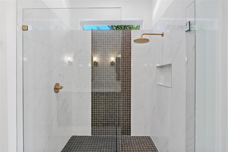 Bathroom featuring a tile shower