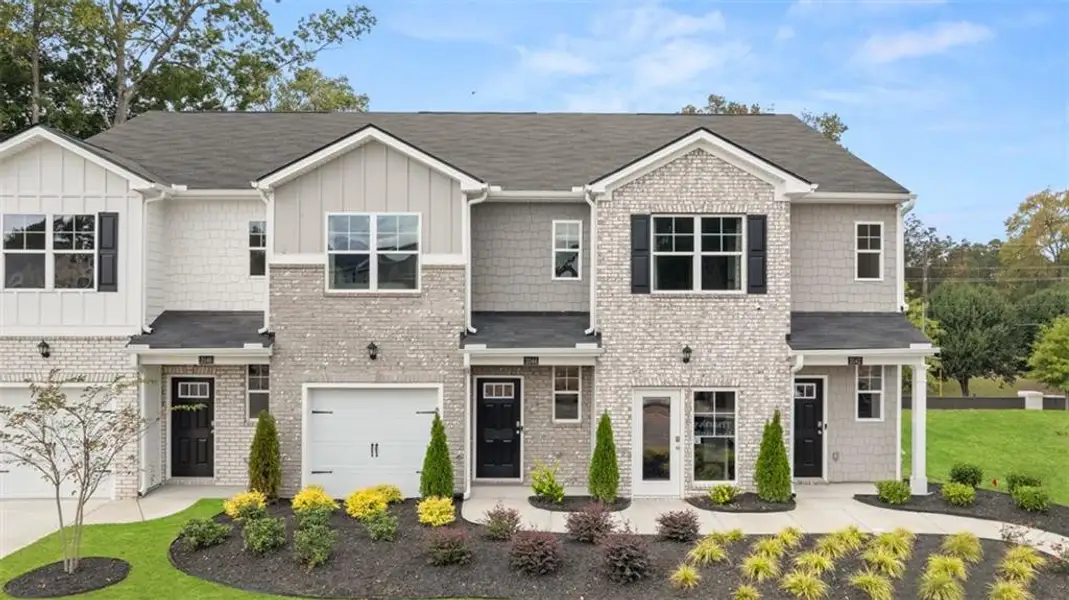 Front exterior of a new home in Young's Crossing, Stone Mountain, GA, highlighting curb appeal (Image 1).