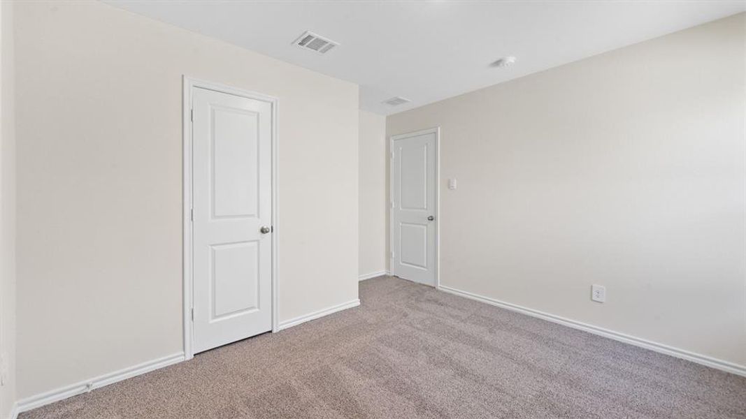 Neutral-toned walls complement the gray carpeting