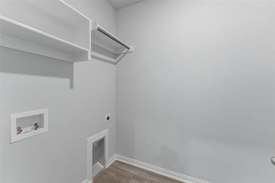 Laundry area featuring washer hookup, light wood-style flooring, and hookup for an electric dryer