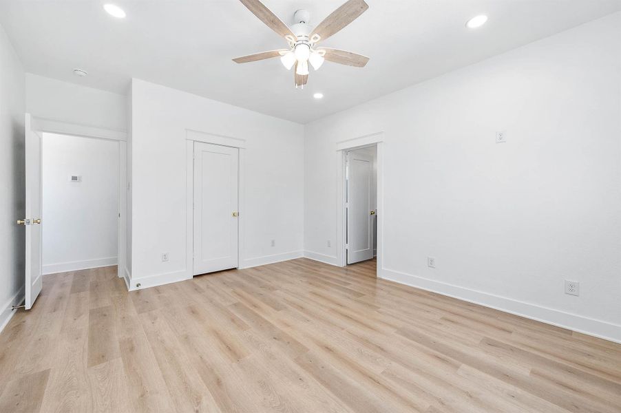 Alternate view of the primary bedroom showcasing access to the walk-in closet.