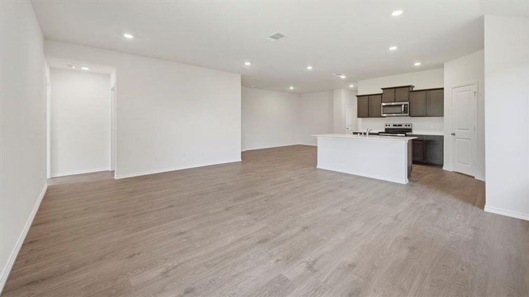 Unfurnished living room featuring recessed lighting and light wood-style flooring Unfurnished living room featuring recessed lighting and light wood-style flooring