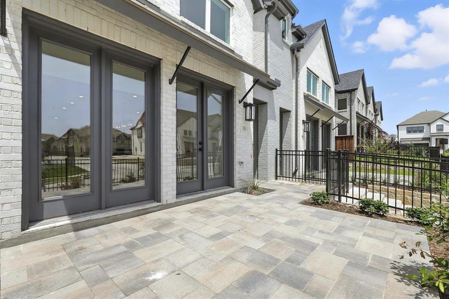 View of exterior entry featuring a residential view, brick siding, french doors, and a patio View of exterior entry featuring a residential view, brick siding, french doors, and a patio