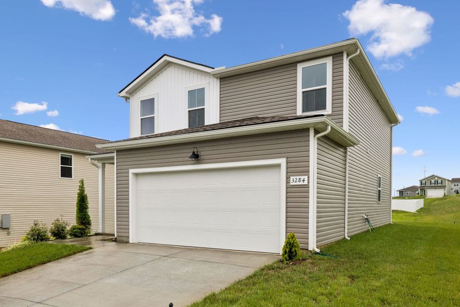 Front exterior of a new home in Highlands of Carter's Station, Columbia, TN, highlighting curb appeal (Image 24).