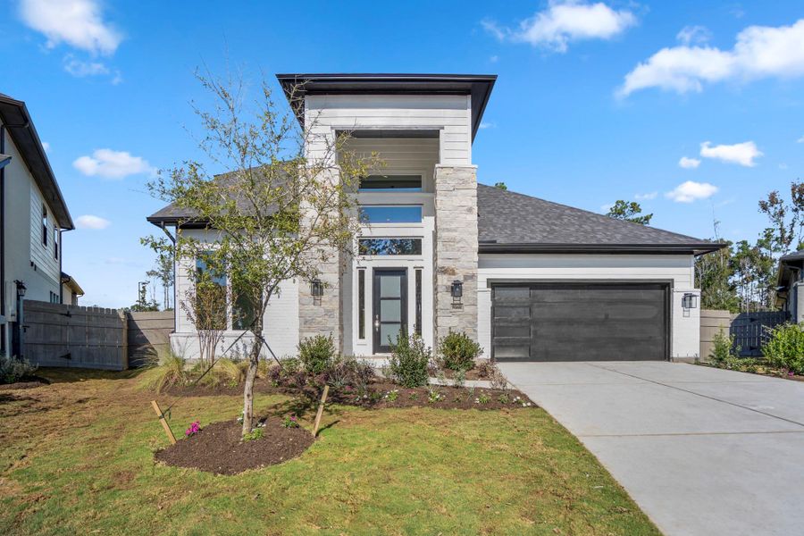 Front exterior of a new home in Artavia, Conroe, TX, highlighting curb appeal (Image 2). Front exterior of a new home in Artavia, Conroe, TX, highlighting curb appeal (Image 2).