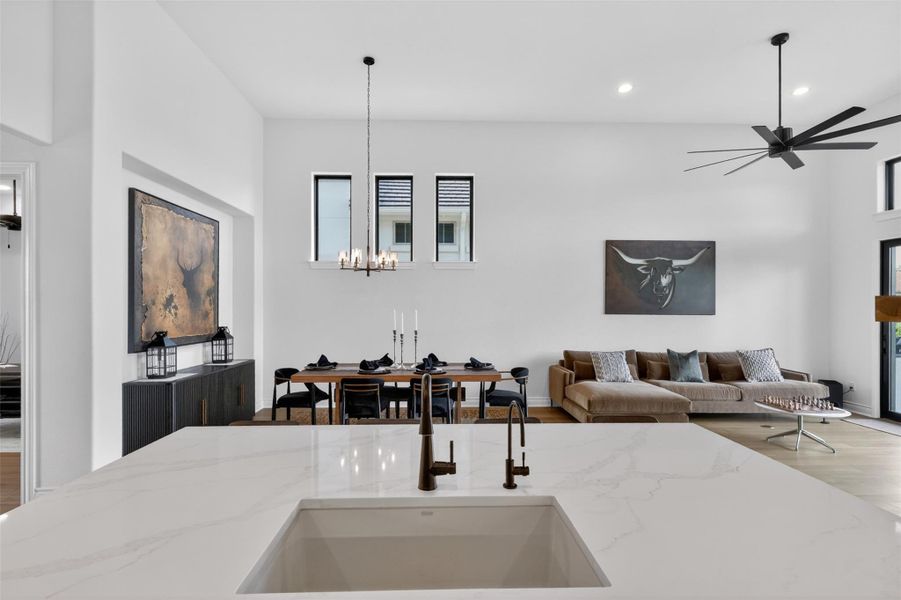 Clean lines and high ceilings define this open-concept living space, offering generous room for entertaining. Clean lines and high ceilings define this open-concept living space, offering generous room for entertaining.