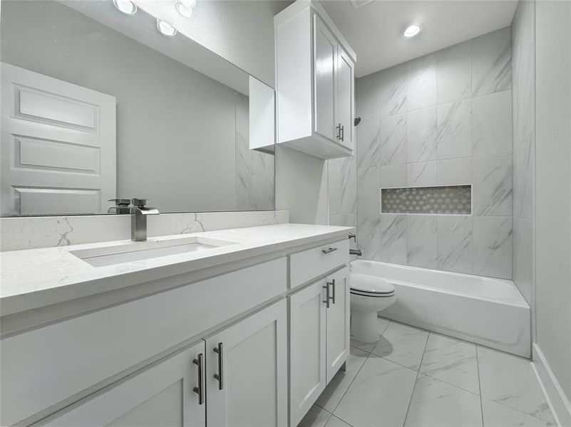 Full bath with vanity, light marble finish flooring, and shower / washtub combination Full bath with vanity, light marble finish flooring, and shower / washtub combination