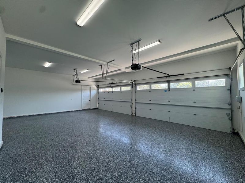 Garage featuring storage room and garage opener