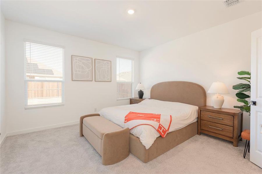 Bedroom featuring light colored carpet and recessed lighting Bedroom featuring light colored carpet and recessed lighting