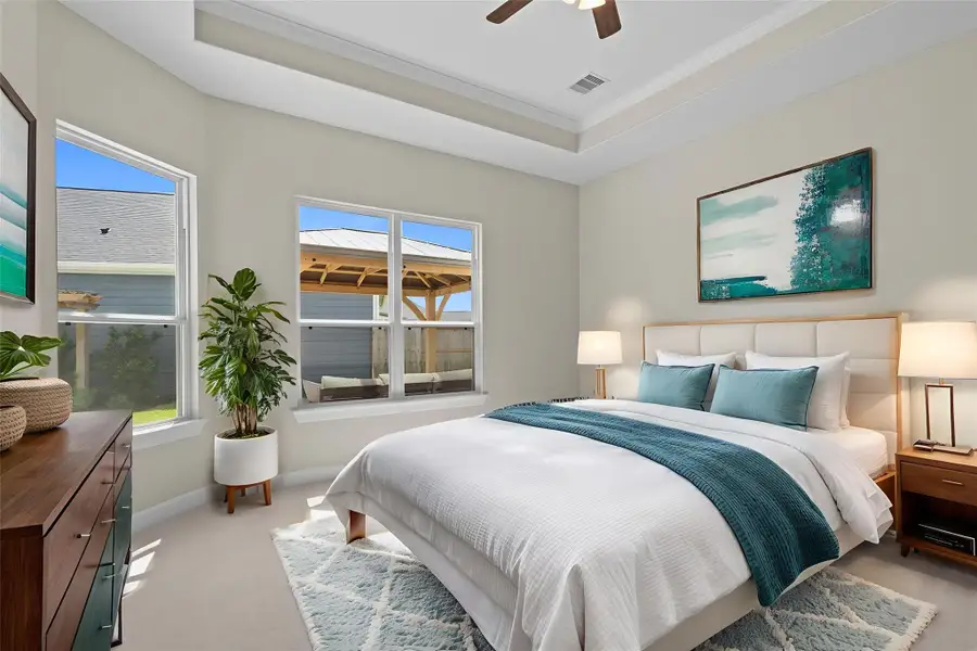 Discover the epitome of luxury and tranquility in the Portico's primary bedroom at Winfrey Estates. This elegant retreat features spacious interiors, exquisite finishes, and a serene ambiance providing the perfect sanctuary. *Image depicts home as-is virtually staged.