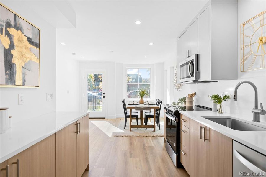 An open-concept kitchen shines with sleek finishes, stainless appliances, and abundant natural light.