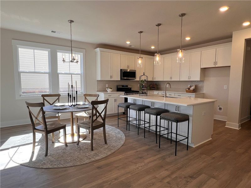 This bright kitchen and dining area features abund This bright kitchen and dining area features abund