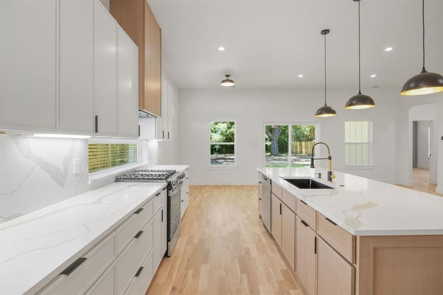 Beautifully appointed quartz countertops, paired with the striking contrast of warm wood accents and crisp white cabinetry, create a bright, airy kitchen that is both timeless and inviting. The thoughtfully designed layout offers abundant workspace, making meal preparation and entertaining an effortless experience. Beautifully appointed quartz countertops, paired with the striking contrast of warm wood accents and crisp white cabinetry, create a bright, airy kitchen that is both timeless and inviting. The thoughtfully designed layout offers abundant workspace, making meal preparation and entertaining an effortless experience.