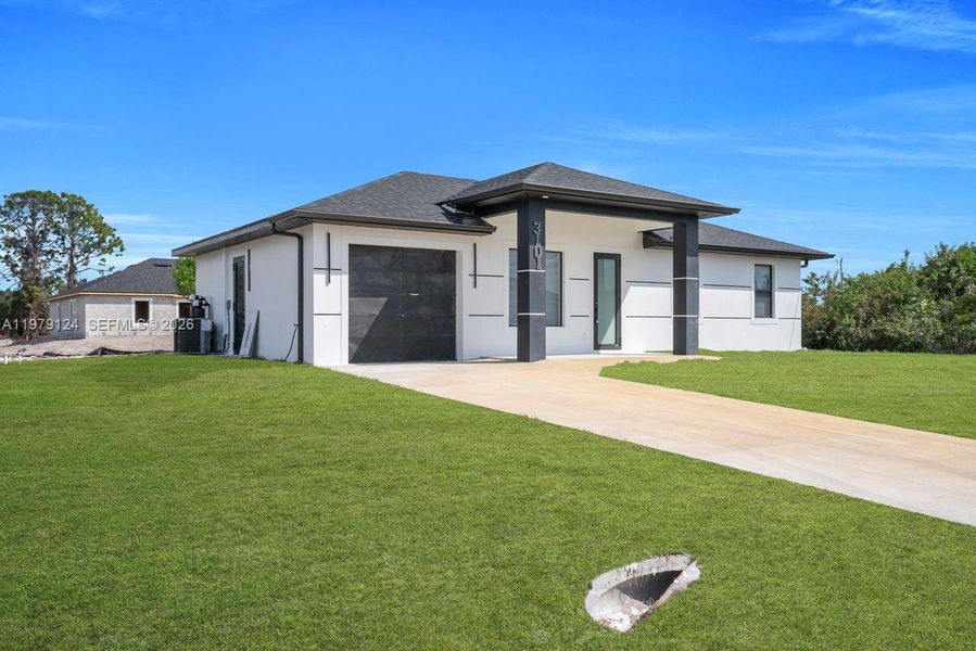 Front exterior of a new home in , Lehigh Acres, FL, highlighting curb appeal (Image 25).