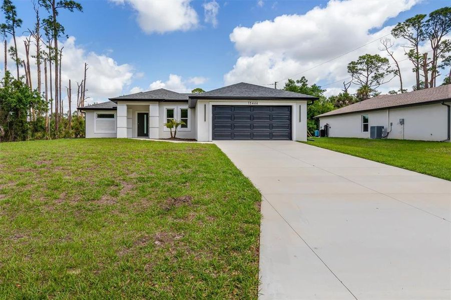 Front exterior of a new home in , Port Charlotte, FL, highlighting curb appeal (Image 17).