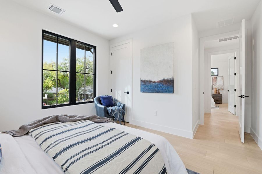 Bedroom featuring light wood-style floors, a ceiling fan, and recessed lighting