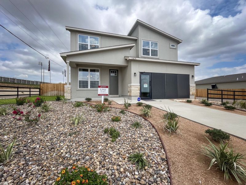 Front exterior of a new home in Villas San Agustin, Laredo, TX, highlighting curb appeal (Image 1).