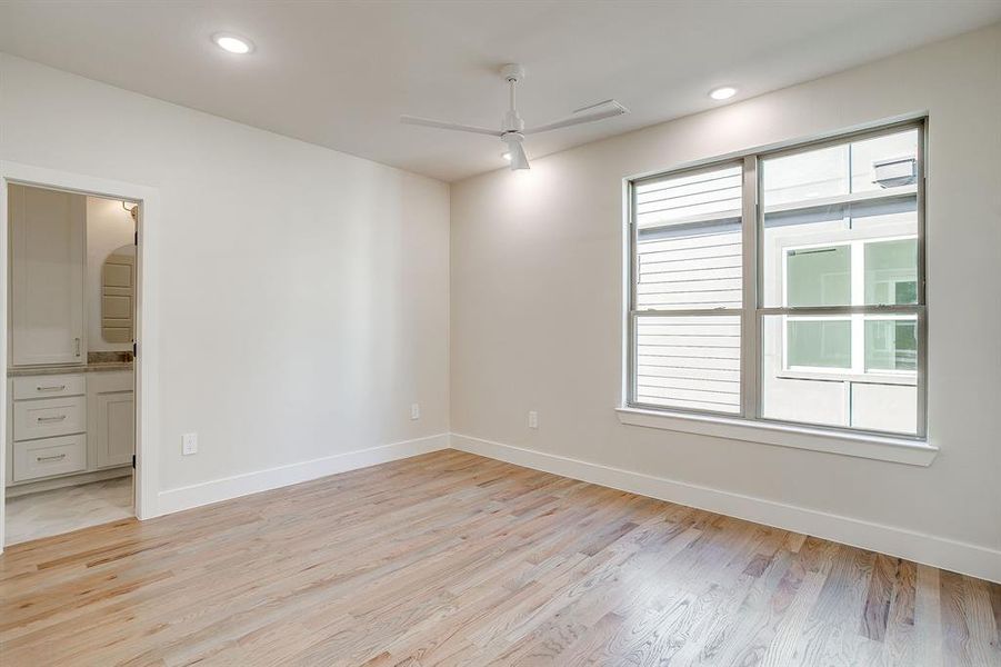 Sophisticated Fort Worth bedroom with real hardwood floors and dark, moody organic design. Sophisticated Fort Worth bedroom with real hardwood floors and dark, moody organic design.