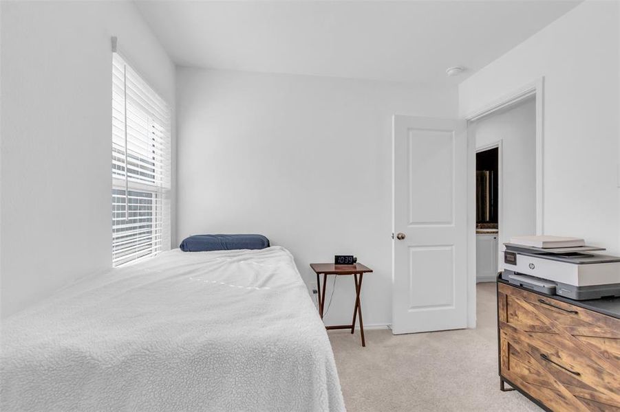 Bedroom with light carpet and baseboards