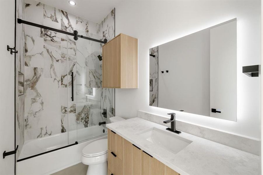 Modern bathroom featuring a single vanity with wood-finish cabinetry, a white countertop, and a rectangular undermount sink