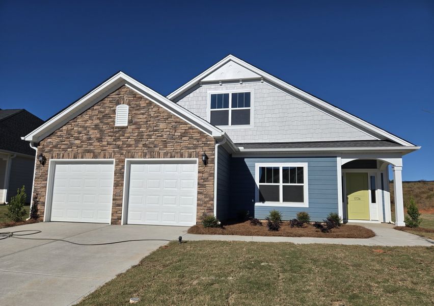 Front exterior of a new home in Cottages at Lake Emory, Inman, SC, highlighting curb appeal (Image 1).