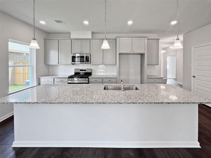 The Crawford- Kitchen with Large Island. Home under construction. Sample floor plan photo used for illustrative purposes only. Upgrades, selections options, windows and colors may vary. The Crawford- Kitchen with Large Island. Home under construction. Sample floor plan photo used for illustrative purposes only. Upgrades, selections options, windows and colors may vary.