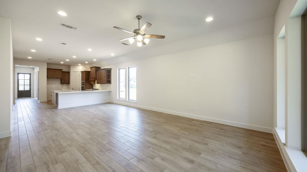 Unfurnished living room featuring light wood-style flooring, recessed lighting, and a ceiling fan