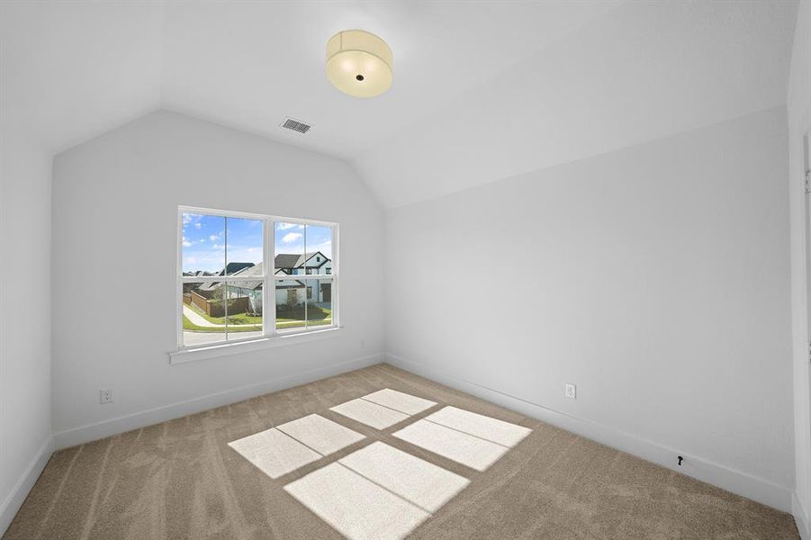 Bonus room with light carpet and lofted ceiling Bonus room with light carpet and lofted ceiling